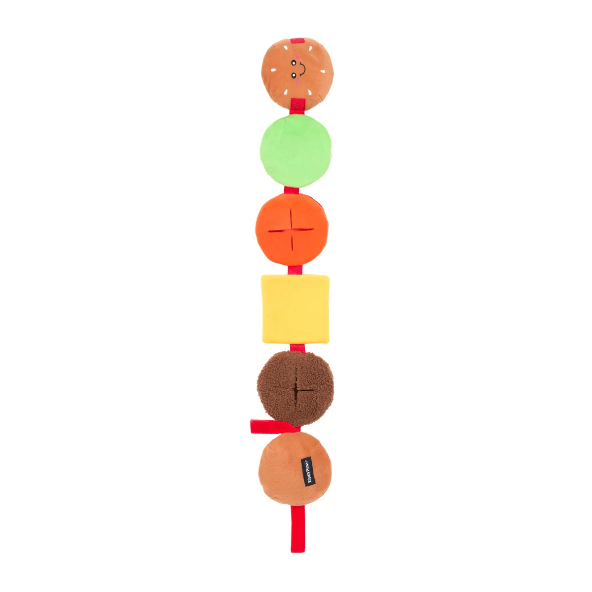 Colorful dog toy with various layers on a white background. Layers include lettuce, tomatoes, cheese, meat, and buns